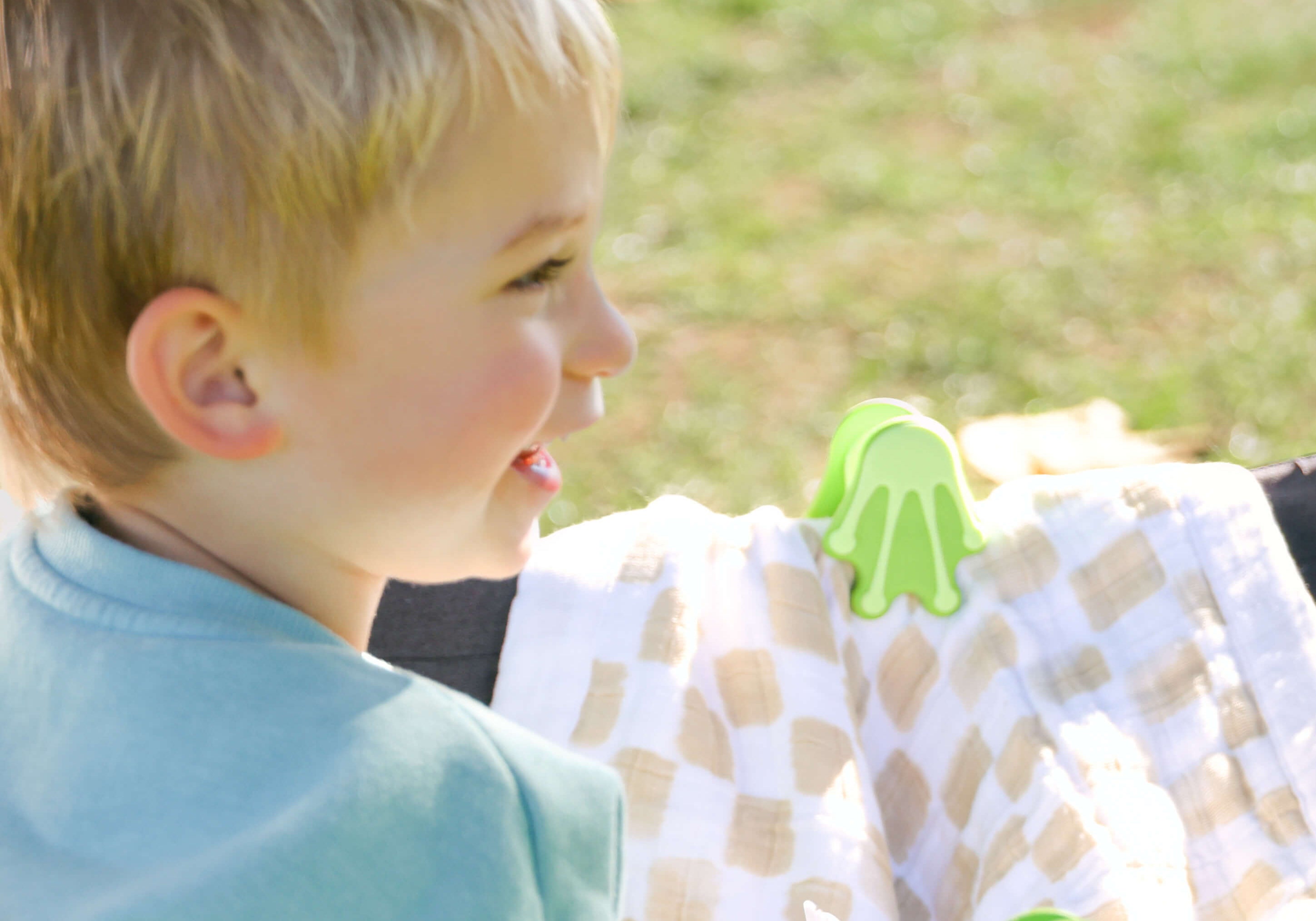 toddler with whimSi clips stroller and wagon accessories