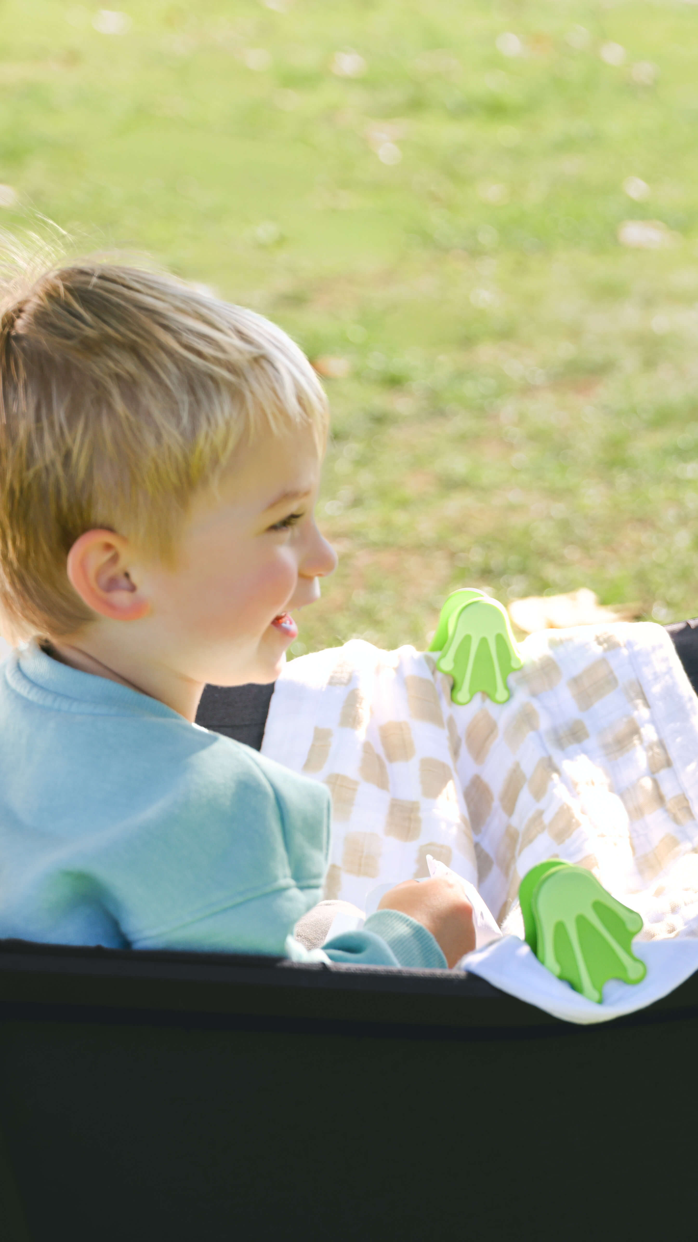 toddler with whimSi clips stroller and wagon accessories