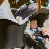 whimSi clips, soft silicone spring clips holding breathable blanket over bassinet to shield the hot sun while keeping baby cool 