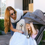Mom and Daughter stroller walk with whimSi clips holding blankets in place securely and safely.