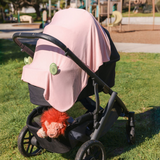 Pinch-free silicone stroller clip holding a blanket on a baby stroller, top baby registry pick 2026 | Best stroller blanket clip for keeping baby warm and cozy, prevents blankets from falling or dragging