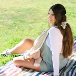 Mom nursing with a blanket held in place by whimSi clips, showing easy, hands-free coverage | Breastfeeding privacy clip for nursing cover, hands-free blanket holder for new moms, versatile baby essential for discreet feeding