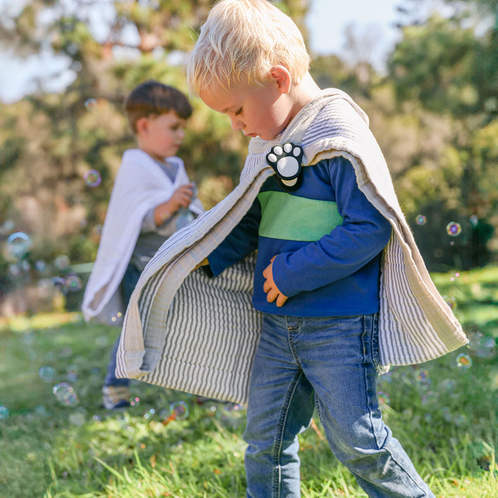 Child playing with blankets held in place by whimSi clips, top baby registry pick 2026