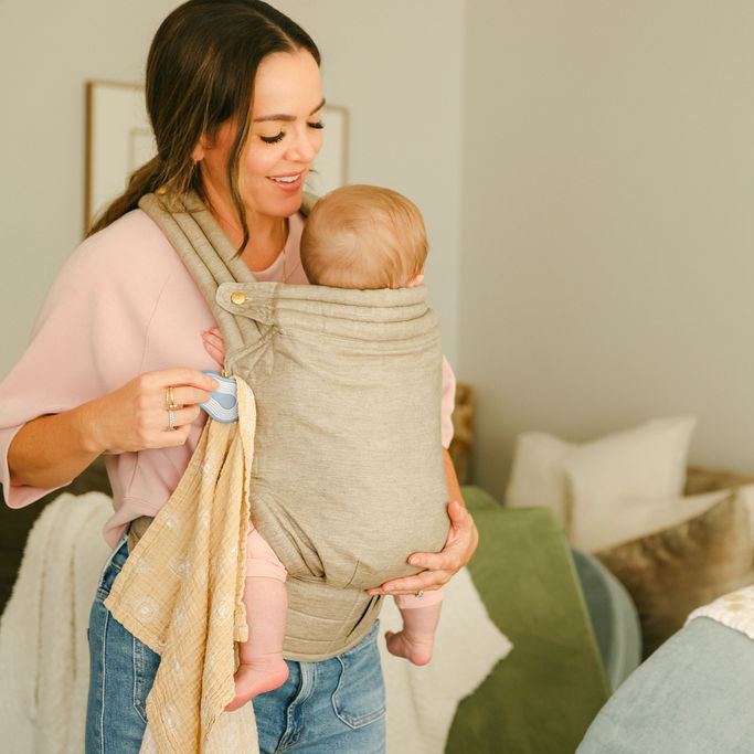Mom babywearing newborn with Water whimSi clip securing blanket